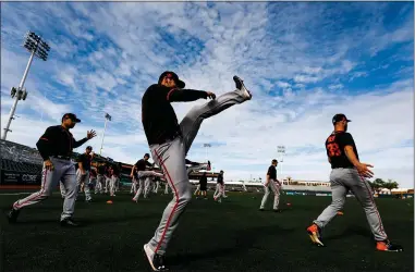  ?? PHOTOS BY RANDY VAZQUEZ — STAFF ARCHIVES ?? San Francisco Giants pitchers warm up during spring training at Scottsdale Stadium in Scottsdale, Ariz., on Feb. 21. The baseball season has been put on hold as the coronaviru­s spreads around the country.