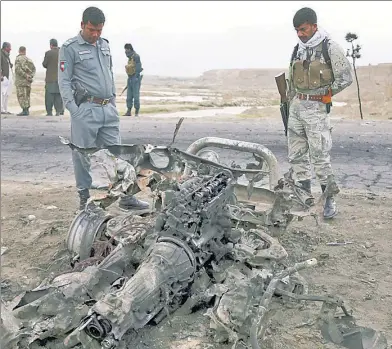  ??  ?? TARGETED? Afghan security forces gather near Bagram Air Base after a terror attack killed three US service members.