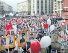  ?? IVAN SEKRETAREV/THE ASSOCIATED PRESS ?? People carry portraits of relatives who fought in the Second World War during the Immortal Regiment march at the Red Square in Moscow, Russia.