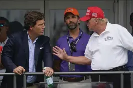  ?? SETH WENIG — THE ASSOCIATED PRESS, FILE ?? Former President Donald Trump talks with Donald Trump Jr. and Tucker Carlson during the final round of the LIV Golf tournament in Bedminster, N.J.