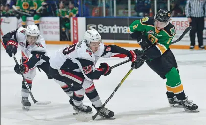 ?? STEVEN MAH/SOUTHWEST BOOSTER ?? Broncos’ rookie Riley Stotts tried to break free from the hook of Moose Jaw’s Matt Sozanski during a 2-1 win Friday.