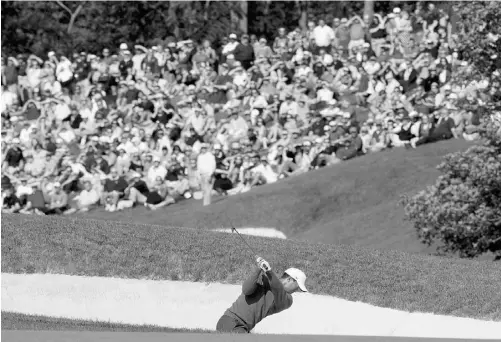  ?? JOHN SOMMERS II, REUTERS ?? Tiger Woods chips out of the sand during the third round of the Memorial Tournament in Dublin, Ohio, on Saturday.