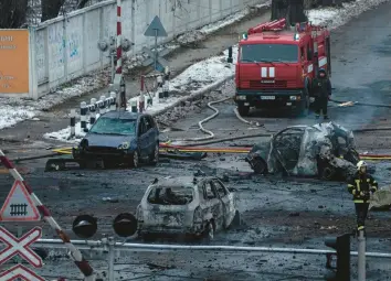  ?? EVGENIY MALOLETKA/AP ?? A firefighte­r walks among destroyed cars after a Russian rocket attack Wednesday in Kyiv, Ukraine.