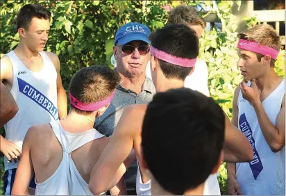  ?? Photo by Ernest A. Brown ?? After 43 years of coaching cross country and track and field, Cumberland’s Tom Kenwood (wearing hat) coached his final dual meet Tuesday at the Cumberland Monastery. Cumberland mayor Bill Murray proclaimed Oct. 3 “Tom Kenwood Day.”