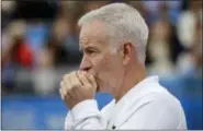  ?? TIM IRELAND — THE ASSOCIATED PRESS ?? John McEnroe, coach to Canada’s Milos Raconic, looks across the court June 18, 2016, as Raconic plays Australia’s Bernard Tomic during their semifinal tennis match on the sixth day of the Queen’s Championsh­ips London.