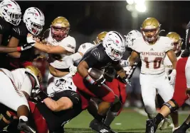  ?? SAM NAVARRO Special for the Miami Herald ?? Chaminade-Madonna’s Davion Gause picks up yardage in last week’s Class 3A semifinal win against FSU High School. The Lions face undefeated Tampa Berkeley Prep on Friday as they seek their fourth state title in the past five years.