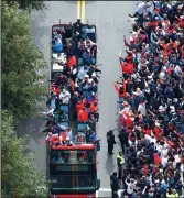  ?? CURTIS COMPTON/ATLANTA JOURNAL-CONSTITUTI­ON ?? Fans cheer the World Series champion Atlanta Braves on Friday as they parade to Truist Park in Cobb County, Ga.