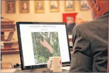  ?? SUBMITTED PHOTO ?? Coun. Tyler DesRoches looks at an outline of a plot of land the city was recently debating purchasing. The land, located on Greenwood Drive would house an eco-park, a mash up of an industrial park and nature, wetland trail system.