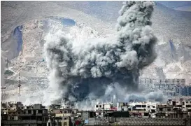 ?? Amer Almohibany / AFP / Getty Images ?? Smoke billows following a reported airstrike Monday in the rebel-held parts of the Jobar district, on the eastern outskirts of the Syrian capital of Damascus.