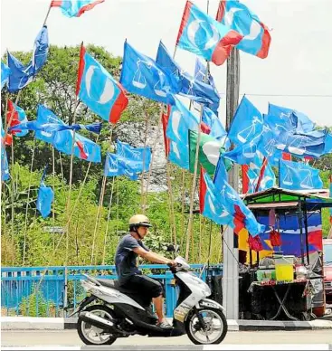  ??  ?? The flag war begins: Even before the dissolutio­n of Parliament, many parts of the country are festooned with flags and banners of the various parties. And things are set to get more intense now.