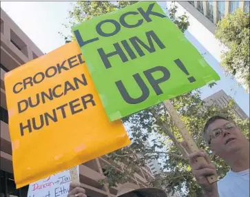  ?? Photograph­s by John Gibbins San Diego Union-Tribune ?? A PROTEST outside a federal courthouse in San Diego denounces Rep. Duncan Hunter who, along with his wife, has been charged with using campaign funds for personal expenses and claiming some as charitable gifts.