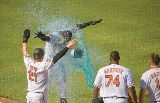  ?? KARL MERTON FERRON/BALTIMORE SUN ?? Orioles outfielder Anthony Santander gets sprayed with Gatorade while heading toward home plate after his walk-off three-run home run against the Yankees on Thursday. The 9-6 win at Oriole Park at Camden Yards ended the Orioles’ six-game losing streak.