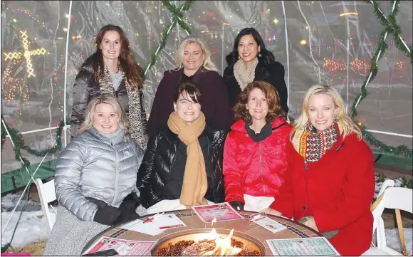  ?? (NWA Democrat-Gazette/Carin Schoppmeye­r) ?? Natalie Lindsey (seated, from left), Denise Dossett, Amber McAllister; Allyn Elleman; Eve McCain (standing, from left), Pam Walters and Helen Urban enjoy the Holidaze sixth annual Nog Off egg nog competitio­n Dec. 15 in the Bradberry Rose Garden at the Walton Arts Center in Springdale.