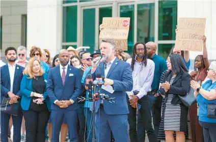  ?? RICH POPE/ORLANDO SENTINEL ?? Eric Gray, CEO of the Christian Service Center, speaks outside the George C. Young Federal Building and Courthouse in downtown Orlando on Monday as nonprofit and community leaders joined to speak out about the rights of homeless people.