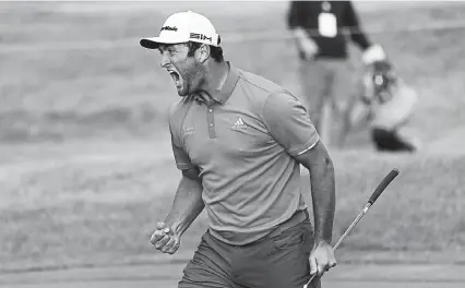  ?? Charles Rex Arbogast, The Associated Press ?? Jon Rahm reacts after making his putt on the first playoff hole during the final round of the BMW Championsh­ip golf tournament at the Olympia Fields Country Club in Olympia Fields, Ill., on Sunday.