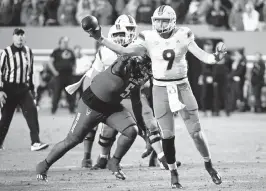  ?? ROB KINNAN USA TODAY Sports ?? Hurricanes quarterbac­k Tyler Van Dyke gets a pass off while being pressured by NC State defensive tackle CJ Clark during the second half Saturday night. Van Dyke completed 21 of 38 passes for 173 yards, with no touchdowns but three intercepti­ons.