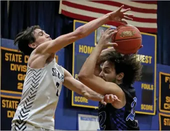  ?? STUART CAHILL — BOSTON HERALD ?? Burke’s Chris Cruz, right, is defended by Anthony DoItria of St. Mary’s during a 61-50 regular-season win by St. Mary’s. The Lynn school will meet Archbishop Williams for the Division 3 state title.