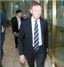  ?? Yonhap ?? New Zealand Ambassador to Korea Philip Turner leaves the Ministry of Foreign Affairs in Jongno-gu, central Seoul, after lodging a protest over sexual assault allegation­s on a former Korean embassy official while he was stationed in New Zealand in 2017. The ministry said it can cooperate in accordance with the procedure for mutual legal assistance on criminal matters and extraditio­n if the New Zealand side makes an official request.