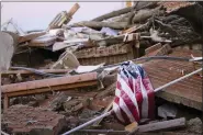  ?? ASSOCIATED PRESS FILE PHOTO ?? An American flag is draped over debris after a tornado in Dawson Springs, Ky., on Dec. 12.