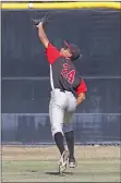  ?? Katharine Lotze/The Signal ?? Hart’s Kendall Thomas reaches to catch a fly ball during a baseball game at Saugus on Wednesday. Hart went on to win 8-7.