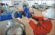  ?? GUO JUNFENG / FOR CHINA DAILY ?? A technician adjusts a valve on a China-Russia oil pipeline in Daqing, Heilongjia­ng province.