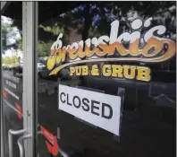  ?? (Arkansas Democrat-Gazette/Staton Breidentha­l) ?? A closure sign is taped Monday to the front door of Brewski’s Pub & Grub in Little Rock.