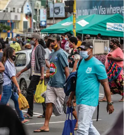  ?? Photo: Leon Lord ?? Members of the public going about their normal day in Suva City.