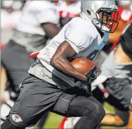  ?? Patrick Connolly ?? Las Vegas Review-journal @Pconnpie UNLV sophomore Charles Williams, running the ball during training camp at Rebel Park on Tuesday, leads a deep unit of Rebels running backs this season.