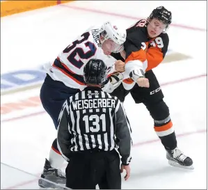  ?? NEWS PHOTO RYAN MCCRACKEN ?? Medicine Hat Tigers forward Zach Fischer and Regina Pats forward Robbie Holmes fight during the second period of Friday's Western Hockey League game at the Canalta Centre.