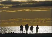  ?? Genaro Molina Los Angeles Times ?? CLOUDS pass over beachgoers in Venice. Some parts of the region got more than 3 inches of rain this week.