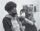  ?? Jon Shapley / Staff photograph­er ?? Animi Williams, 14, winces as she gets a shot from Jallesse Flores in a Moderna vaccine trial for teens Saturday at CyFair Clinical Research Center in Houston.