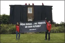  ?? LUCA MARINO — GREENPEACE VIA AP ?? Greenpeace activists draped the country estate of British Prime Minister Rishi Sunak in black fabric to protest his plan to expand oil drilling in the North Sea.