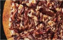  ?? Little Caesar’s ?? Little Caesar’s Smokehouse Pizza has a coating of barbecue seasoning on the crust.