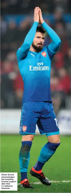  ??  ?? Olivier Giroud acknowledg­es the travelling Arsenal support after their 3-1 defeat to Swansea