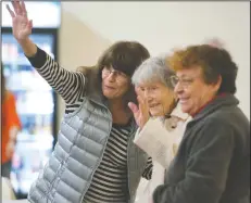  ??  ?? Dixie Belletto, 102, flanked by Carole Romans, right, and Antonia Jarquin, waves to another concert goer during a Pat Yankee and Cell Block 7 traditiona­l jazz band concert at the American Legion Hall in Lodi on Tuesday.