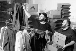  ?? DAMIAN DOVARGANES/AP ?? Actor Daniel Franzese, left, and co-owner Wil Cuadros select clothes for The Winston Box at their showroom in Gardena, Calif. The company makes clothes for bigger guys.
