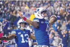  ?? TYLER TATE/ASSOCIATED PRESS ?? BYU running back Lopini Katoa celebrates a touchdown during the first half of the Cougars’ eventual 28-25 victory over 14th-ranked Boise State in Provo, Utah.