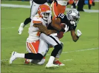  ??  ?? Raiders wide receiver Nelson Agholor (15) is tackled after a gain by Kansas City Chiefs cornerback Bashaud Breeland (21) in the first half at Allegiant Stadium on Sunday in Las Vegas.