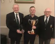  ??  ?? Club captain Martin Hennessy presents the Summer Fourball Cup to George Bradley alongside President Jim Murray.