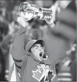  ?? Canadian Press photo ?? Canada forward Dillon Dube (9) hoists the trophy after wining the gold medal, defeating Sweden in the final at the IIHF World Junior Championsh­ip, Friday, in Buffalo, N.Y.