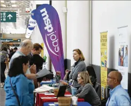  ?? DAVID ZALUBOWSKI / ASSOCIATED PRESS ?? Applicants chat with employers at a July job fair at Minneapoli­s Internatio­nal Airport. On Tuesday, the Labor Department reported that in June, the proportion of workers who quit their jobs hit its highest level in nearly 13 years.