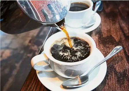  ??  ?? Black tonic: The study found that coffee drinkers had a lower risk of death due to heart disease, cancer, stroke, diabetes, and respirator­y and kidney disease. — AFP
