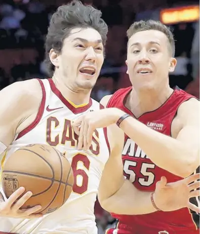  ?? LYNNE SLADKY/AP ?? Heat shooting star Duncan Robinson works defensivel­y Wednesday night against the Cavaliers’ Cedi Osman.