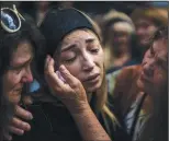  ?? (AP/Emilio Morenatti) ?? Anastasia Ohrimenko, 26, is comforted by relatives Aug. 31 as she cries next to the coffin of her husband, Yury Styglyuk, a Ukrainian serviceman who died in combat Aug. 24 in Maryinka, Donetsk, during his funeral in Bucha, Ukraine.