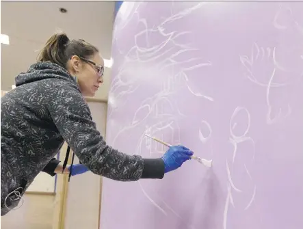  ?? IAN KUCERAK ?? Carla Rae Taylor paints the first mural for the Canada 150 Paint the Rails legacy project in the concourse level at the Churchill LRT Station on Sunday.