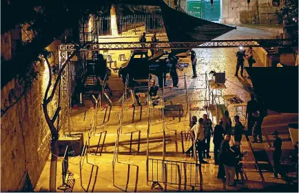  ?? PHOTO: GETTY IMAGES PHOTO: REUTERS ?? Israeli security forces remove metal detectors which were recently installed at an entrance to the compound known to Muslims as Noble Sanctuary and to Jews as Temple Mount, in Jerusalem’s Old City.