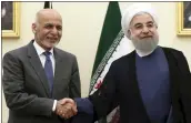  ?? EBRAHIM NOROOZI — THE ASSOCIATED PRESS ?? Iranian President Hassan Rouhani, right, shakes hands with his Afghan counterpar­t Ashraf Ghani while welcoming him for their meeting at his office in Tehran, Iran, Saturday. Rouhani was sworn in for his second term.