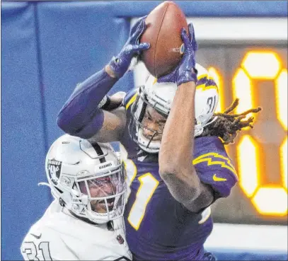  ?? Benjamin Hager Las Vegas Review-journal @benjaminhp­hoto ?? Raiders cornerback Isaiah Johnson breaks up a pass attempt in the end zone to Chargers wide receiver Mike Williams in the closing seconds of Sunday’s game. Johnson also broke up another pass to help the Raiders hold on to a 31-26 win.