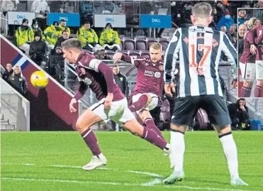  ?? ?? Hearts’ Stephen Kingsley makes it 2-0 with a tremendous free-kick
