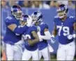  ?? BILL KOSTROUN — THE ASSOCIATED PRESS ?? New York Giants cornerback Donte’ Deayon, center, is congratula­ted after intercepti­ng a pass from New England Patriots quarterbac­k Danny Etling, not pictured, during the first half of an NFL preseason football game, Thursday in East Rutherford.